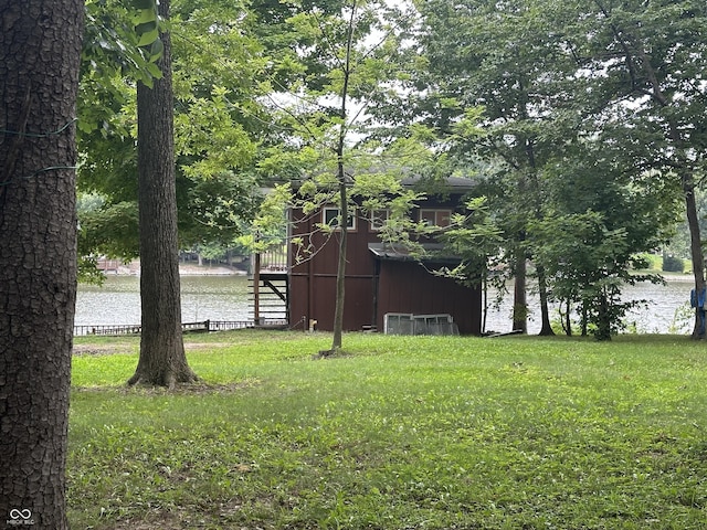 view of yard featuring an outbuilding and a water view