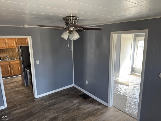 unfurnished dining area featuring baseboards, visible vents, ceiling fan, and dark wood-style flooring