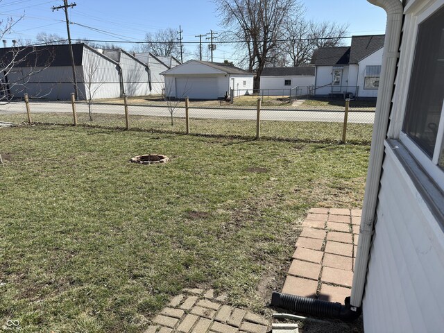 view of yard with a garage, a residential view, and fence