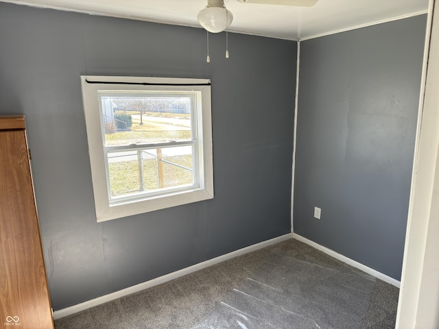 carpeted spare room with baseboards