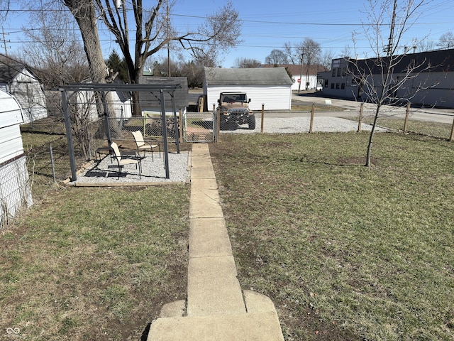 view of yard with a patio area, fence, and a gate