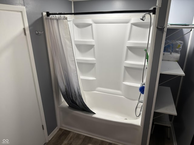 bathroom featuring shower / tub combo and wood finished floors