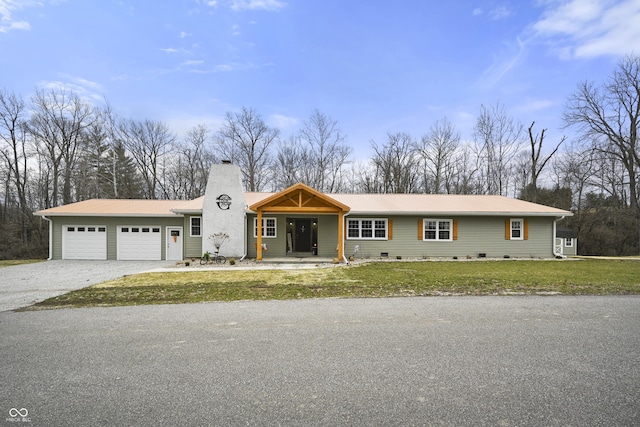 view of front of property featuring a garage, crawl space, a chimney, a front yard, and gravel driveway