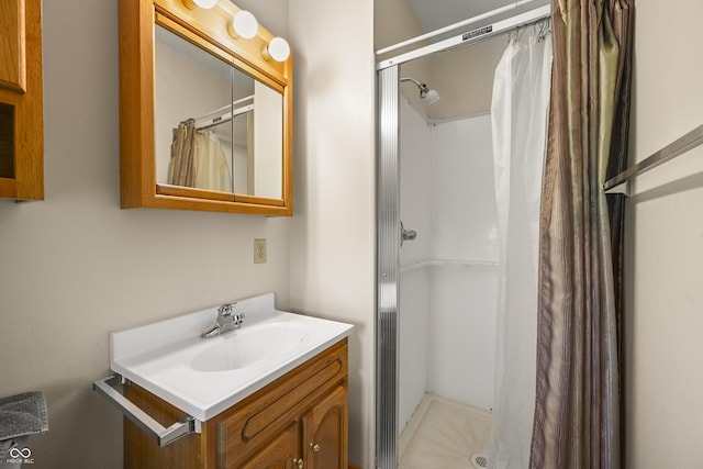 full bath featuring a stall shower and vanity