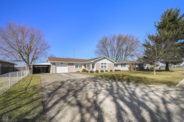 view of front of property featuring a front yard, fence, driveway, an attached garage, and brick siding