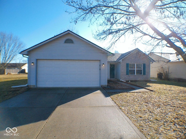 single story home with concrete driveway, brick siding, and an attached garage