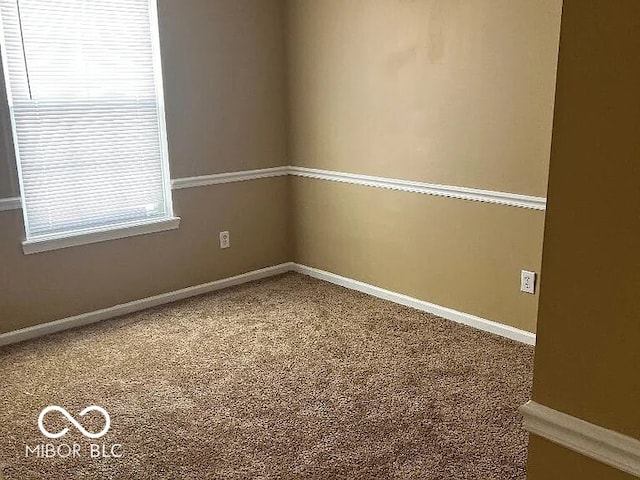 unfurnished room featuring baseboards