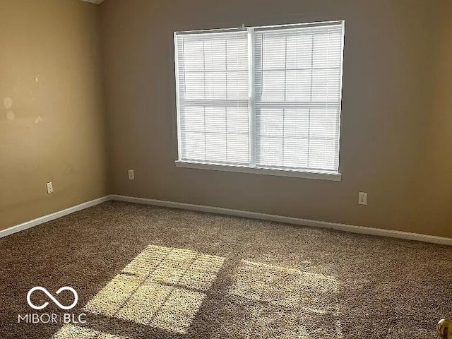 unfurnished room with baseboards