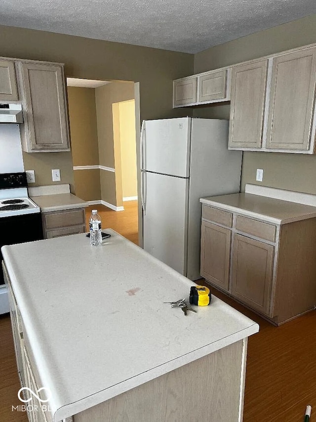 kitchen featuring a textured ceiling, under cabinet range hood, black range with electric stovetop, light countertops, and freestanding refrigerator