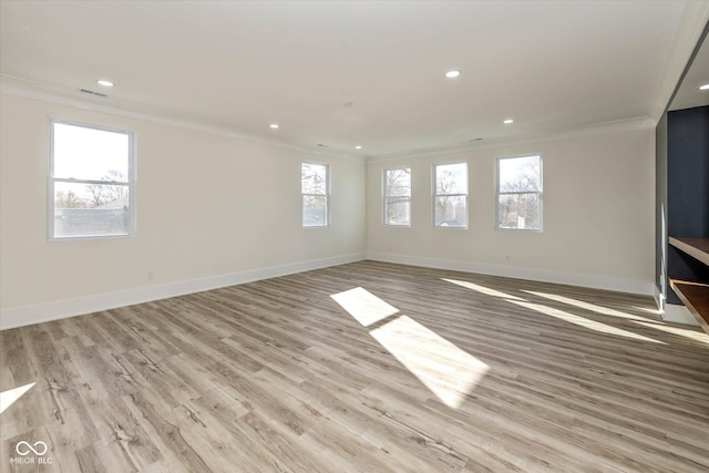 unfurnished living room featuring crown molding, light wood-style flooring, recessed lighting, and baseboards