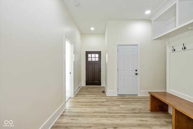 mudroom with recessed lighting, light wood-style flooring, and baseboards