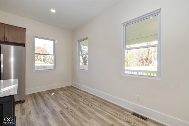 interior space featuring light wood-style flooring, recessed lighting, visible vents, and baseboards