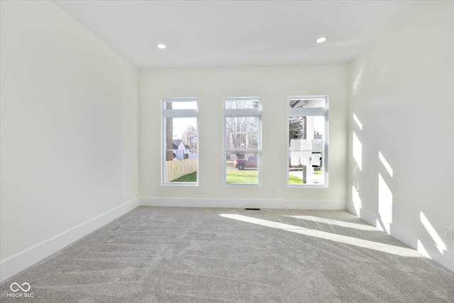 carpeted spare room with recessed lighting and baseboards