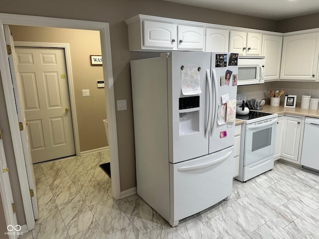 kitchen featuring white appliances, decorative backsplash, light countertops, white cabinets, and marble finish floor