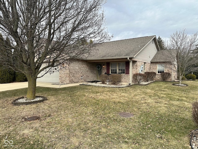 view of front of home featuring roof with shingles, an attached garage, concrete driveway, a front lawn, and brick siding