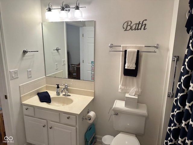 full bathroom with tasteful backsplash, toilet, and vanity