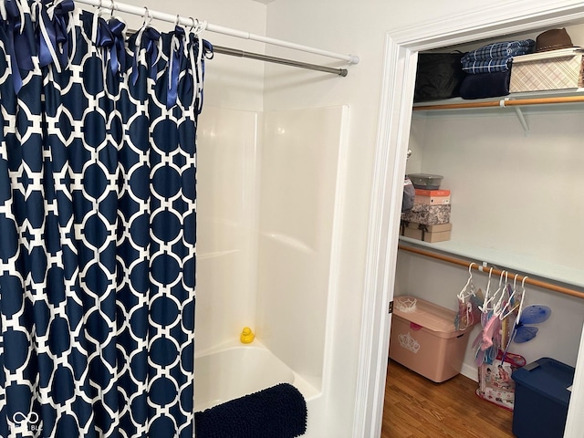 bathroom featuring shower / bath combination with curtain and wood finished floors