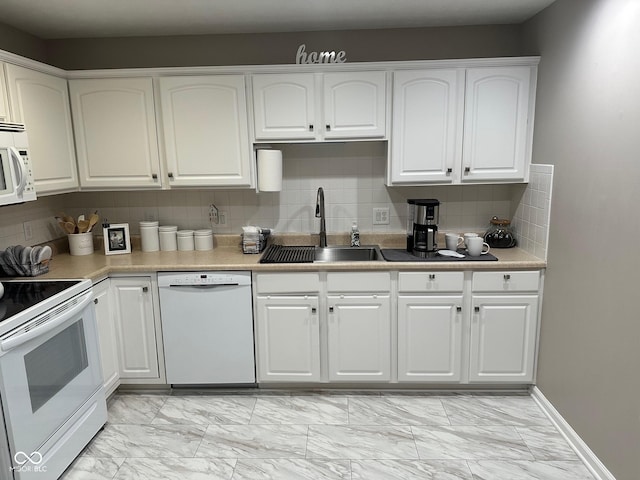 kitchen with white appliances, white cabinets, marble finish floor, and a sink