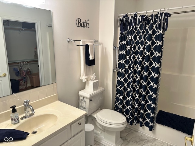 bathroom with tasteful backsplash, marble finish floor, toilet, and vanity