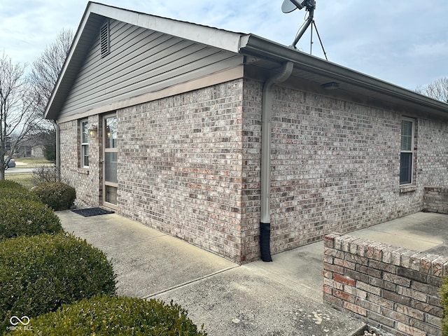 view of side of home featuring brick siding