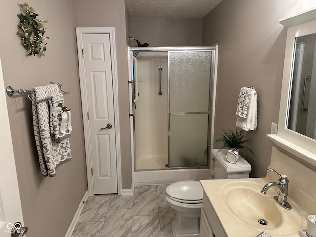 full bathroom with vanity, baseboards, a shower stall, toilet, and marble finish floor