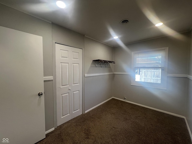 unfurnished room with recessed lighting, baseboards, visible vents, and dark colored carpet