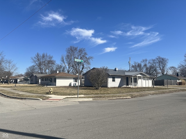 view of front facade featuring an attached garage, driveway, and fence