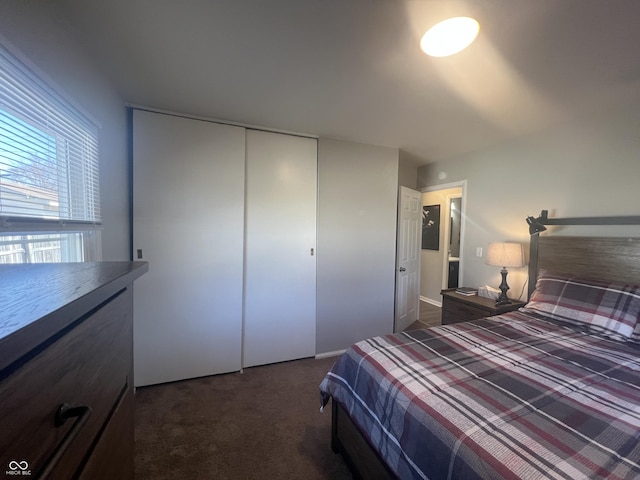 unfurnished bedroom with a closet and dark carpet