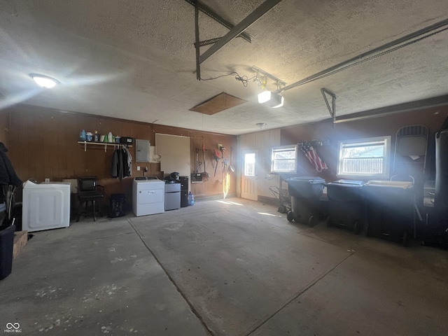 garage with washer and clothes dryer and electric panel