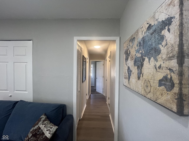 hallway featuring wood finished floors and baseboards