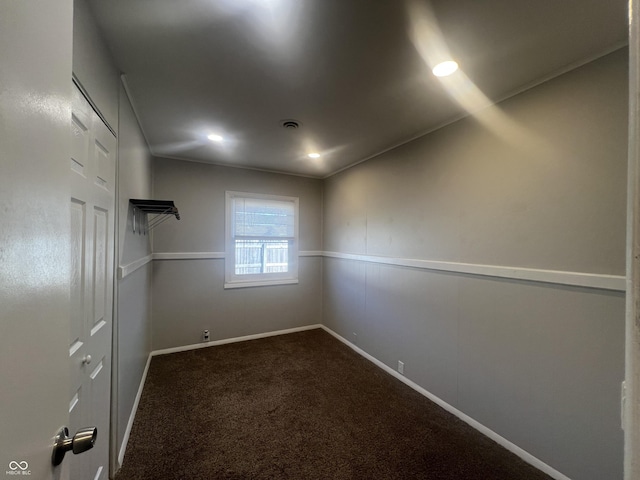 unfurnished room featuring dark colored carpet, visible vents, baseboards, and recessed lighting