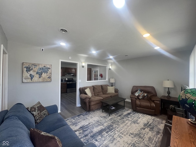 living area featuring recessed lighting, wood finished floors, and visible vents