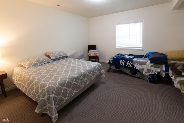 carpeted bedroom featuring baseboards