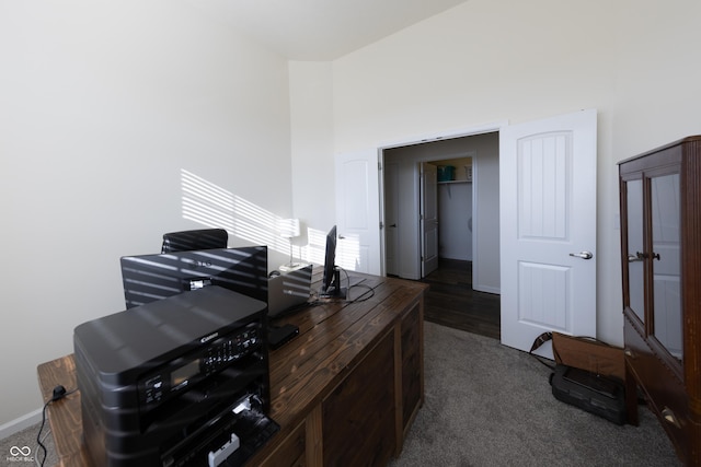 office with dark carpet, a high ceiling, and baseboards