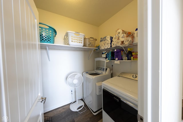 washroom with dark wood-type flooring, independent washer and dryer, and laundry area