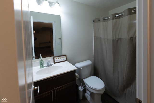 bathroom with vanity, a shower with shower curtain, and toilet