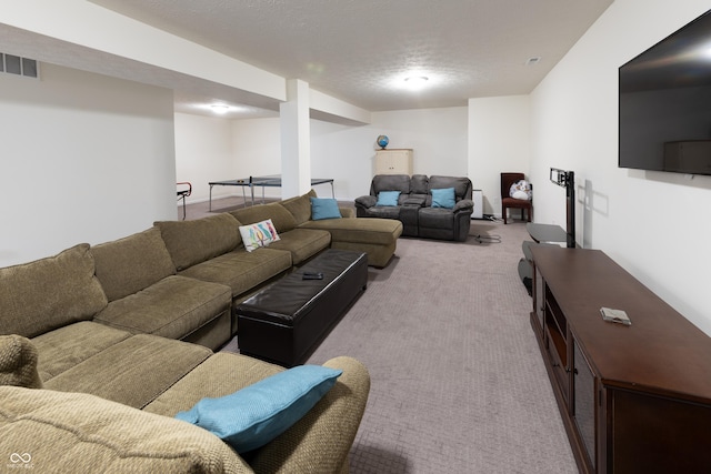 carpeted living area with visible vents and a textured ceiling