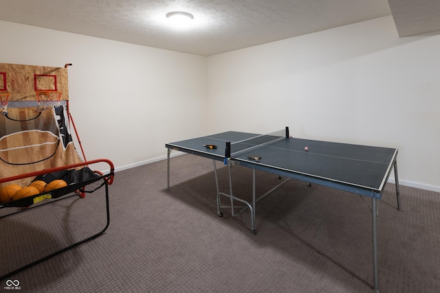 playroom with baseboards, a textured ceiling, and carpet