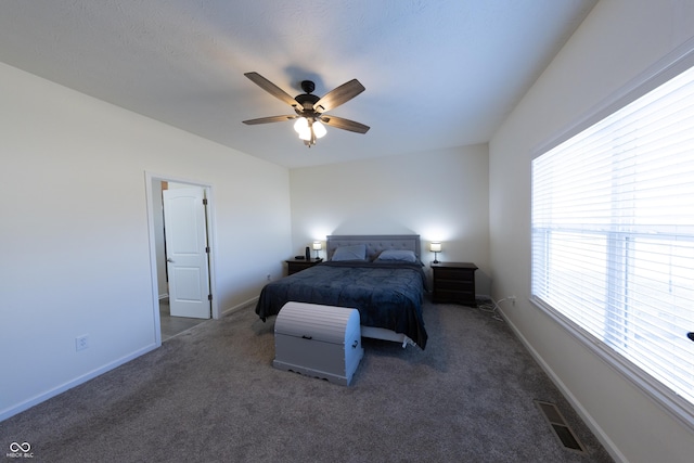 carpeted bedroom featuring visible vents, a ceiling fan, and baseboards