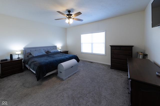 carpeted bedroom featuring baseboards and a ceiling fan