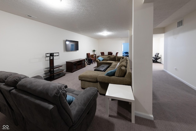 living area with baseboards, visible vents, a textured ceiling, and carpet