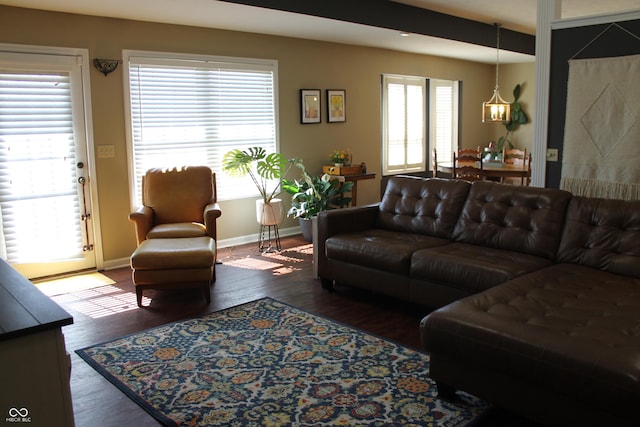 living room with baseboards, wood finished floors, and a healthy amount of sunlight