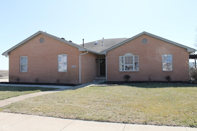 ranch-style home featuring brick siding and a front yard