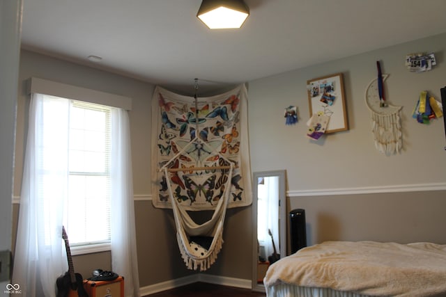 bedroom with multiple windows and baseboards