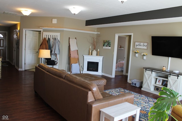 living area featuring baseboards, a fireplace, visible vents, and dark wood-style flooring