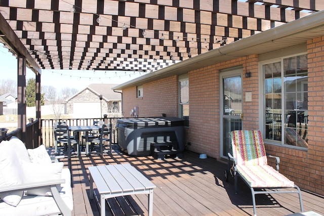 deck featuring grilling area, a pergola, and outdoor dining space