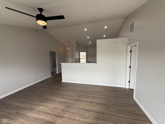 unfurnished living room featuring ceiling fan, dark wood-type flooring, visible vents, and baseboards