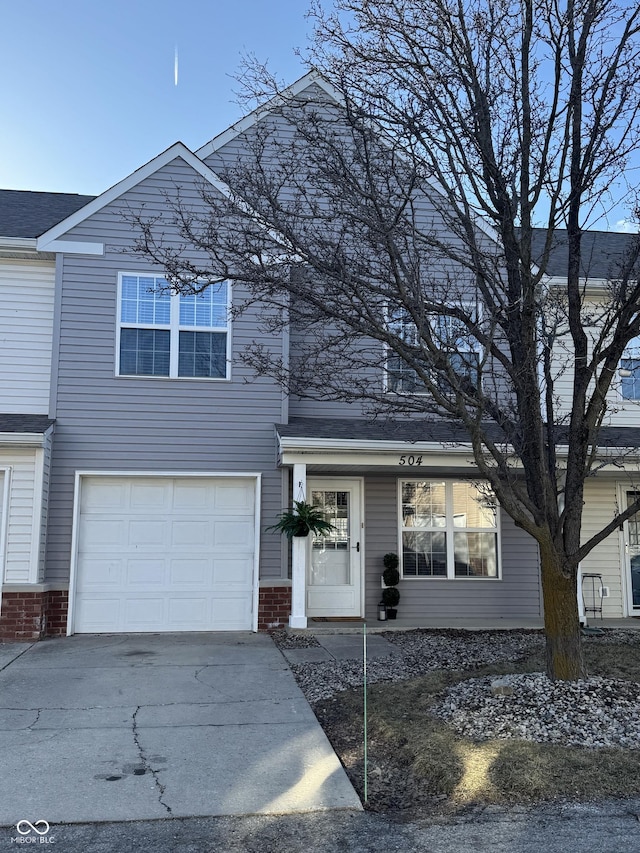 traditional-style house with an attached garage, brick siding, and driveway