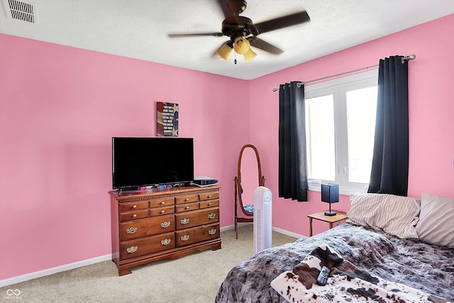 bedroom featuring visible vents, baseboards, ceiling fan, and carpet flooring