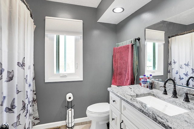 full bath with vanity, curtained shower, toilet, and baseboards